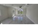 Airy living room with access to a balcony, recessed lights and modern tile floors at 1240 Solitude Ln, Sarasota, FL 34242