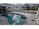 Inviting screened pool with brick pavers and a spillover waterfall feature, perfect for relaxation and outdoor enjoyment at 1240 Solitude Ln, Sarasota, FL 34242