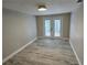 Cozy room with a light fixture and glass doors that lead to the outside at 1240 Solitude Ln, Sarasota, FL 34242