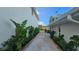 View of the side yard, featuring gravel, wood planters, and various green plants and shrubs at 1240 Solitude Ln, Sarasota, FL 34242