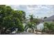 Scenic water view featuring lush greenery and the architectural style of neighboring waterfront homes at 1240 Solitude Ln, Sarasota, FL 34242