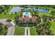 Aerial view of community pool, clubhouse and lake at 13422 Saw Palm Creek Trl, Lakewood Ranch, FL 34211