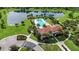 Aerial view of the community pool, lush landscaping, and a tranquil lake at 13422 Saw Palm Creek Trl, Lakewood Ranch, FL 34211