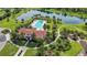 Overhead shot showcasing community pool, verdant landscaping, and a tranquil lake at 13422 Saw Palm Creek Trl, Lakewood Ranch, FL 34211