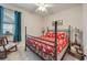 Comfortable bedroom with a four-poster bed, ceiling fan, and bright natural light from the window at 13422 Saw Palm Creek Trl, Lakewood Ranch, FL 34211
