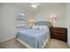 Comfortable bedroom featuring a ceiling fan and an area rug at 13422 Saw Palm Creek Trl, Lakewood Ranch, FL 34211