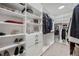 Organized walk-in closet with custom shelving, drawers, and ample storage space at 13422 Saw Palm Creek Trl, Lakewood Ranch, FL 34211
