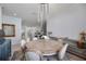 Bright dining area with table for six and view into kitchen and living spaces at 13422 Saw Palm Creek Trl, Lakewood Ranch, FL 34211