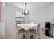 Bright dining area features a modern chandelier, neutral decor, and a window view at 13422 Saw Palm Creek Trl, Lakewood Ranch, FL 34211
