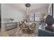 Elegant dining room featuring a modern chandelier, neutral color scheme, and sophisticated decor at 13422 Saw Palm Creek Trl, Lakewood Ranch, FL 34211