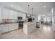 Gleaming kitchen with white cabinets, granite countertops, stainless appliances, and a central island at 13422 Saw Palm Creek Trl, Lakewood Ranch, FL 34211
