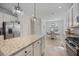 Well-lit kitchen boasting an island, stainless steel appliances, and an adjacent dining space at 13422 Saw Palm Creek Trl, Lakewood Ranch, FL 34211