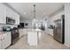 Spacious open kitchen features white cabinetry, granite countertops, and stainless steel appliances at 13422 Saw Palm Creek Trl, Lakewood Ranch, FL 34211