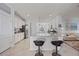 Open kitchen with white cabinets, granite countertops, central island, and stainless steel appliances at 13422 Saw Palm Creek Trl, Lakewood Ranch, FL 34211
