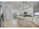 Bright kitchen with white cabinets, granite countertops, stainless appliances, and a central island at 13422 Saw Palm Creek Trl, Lakewood Ranch, FL 34211
