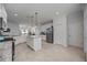 Open-concept kitchen featuring white cabinets, granite counters, stainless steel appliances, and an island at 13422 Saw Palm Creek Trl, Lakewood Ranch, FL 34211