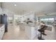 Bright kitchen featuring an island with bar seating, stainless appliances, and an adjacent dining area at 13422 Saw Palm Creek Trl, Lakewood Ranch, FL 34211