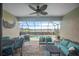 Relax in this screened lanai with brick pavers, comfortable seating, and a view of the pool and lake at 13422 Saw Palm Creek Trl, Lakewood Ranch, FL 34211