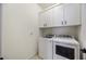 Functional laundry room with a washer, dryer, and storage cabinets at 13422 Saw Palm Creek Trl, Lakewood Ranch, FL 34211