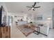 Bright, spacious living room with tile floors, comfortable seating, and a view into the kitchen at 13422 Saw Palm Creek Trl, Lakewood Ranch, FL 34211