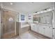 Bright bathroom featuring walk in shower, garden tub, and double vanity at 13422 Saw Palm Creek Trl, Lakewood Ranch, FL 34211