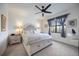 Serene main bedroom with a tufted headboard, soft lighting, and comfortable seating at 13422 Saw Palm Creek Trl, Lakewood Ranch, FL 34211