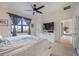 Bright main bedroom featuring built in closet, flat screen TV, ceiling fan and great views at 13422 Saw Palm Creek Trl, Lakewood Ranch, FL 34211