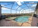 Enclosed pool area with a view of a lake and community at 13422 Saw Palm Creek Trl, Lakewood Ranch, FL 34211