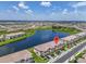 Community aerial showcasing meticulously landscaped grounds, water feature and a neighborhood layout, a perfect overview at 15131 Sunny Day Dr, Bradenton, FL 34211