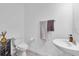 Bright bathroom featuring a vessel sink, decorative cabinet, toilet and modern finishes at 15131 Sunny Day Dr, Bradenton, FL 34211