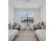 Bright bedroom with matching twin beds, individual desks, neutral color scheme, and a large window providing ample natural light at 15131 Sunny Day Dr, Bradenton, FL 34211