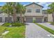 Charming two-story townhome with a two-car garage, lush landscaping, and a welcoming entryway at 15131 Sunny Day Dr, Bradenton, FL 34211