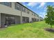 Townhouse backyard featuring a well-maintained lawn and screened patio, ideal for outdoor enjoyment at 15131 Sunny Day Dr, Bradenton, FL 34211