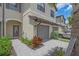 Close-up exterior of townhome showing a stone driveway and entry with beautiful plants at 15131 Sunny Day Dr, Bradenton, FL 34211