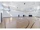 Bright community gymnasium with basketball hoops, wood flooring, and multiple windows at 15131 Sunny Day Dr, Bradenton, FL 34211