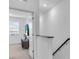 Bright hallway leading to a room with large windows and a comfortable seating area at 15131 Sunny Day Dr, Bradenton, FL 34211