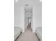 Hallway showing two beds and carpet, with open door showing view to next room at 15131 Sunny Day Dr, Bradenton, FL 34211