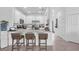 Bright kitchen with white cabinets, stainless steel appliances, granite countertops and bar stool seating at 15131 Sunny Day Dr, Bradenton, FL 34211