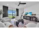 Bright living room with comfortable seating, dark curtains, and large windows with a scenic view at 15131 Sunny Day Dr, Bradenton, FL 34211