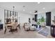Bright and airy living room featuring modern furnishings, a dining area, and large windows with a backyard view at 15131 Sunny Day Dr, Bradenton, FL 34211