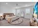 Airy main bedroom featuring a ceiling fan, a large rug, and two windows providing natural light at 15131 Sunny Day Dr, Bradenton, FL 34211