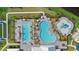 An aerial perspective shows the community's pools, splash area, and lounge spaces, surrounded by lush landscaping at 15716 Barefoot Beach Dr, Bradenton, FL 34211