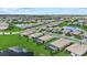 Expansive aerial view of a well-planned community featuring lush green spaces, serene ponds, and beautiful single-Gathering homes at 15716 Barefoot Beach Dr, Bradenton, FL 34211