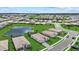 Scenic aerial perspective of a residential neighborhood featuring lush green spaces, tranquil ponds, and inviting single-Gathering homes at 15716 Barefoot Beach Dr, Bradenton, FL 34211