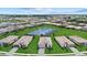 Aerial view of a vibrant community with homes surrounding a beautiful central lake at 15716 Barefoot Beach Dr, Bradenton, FL 34211