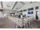 Well-lit bar area featuring an extended countertop with barstool seating and several TV screens at 15716 Barefoot Beach Dr, Bradenton, FL 34211