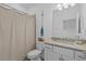 Well-lit bathroom with granite countertop vanity, mirror, and shower-tub combo at 15716 Barefoot Beach Dr, Bradenton, FL 34211