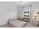 Cozy bedroom with a large window that provides natural light and backyard view at 15716 Barefoot Beach Dr, Bradenton, FL 34211