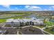 Aerial view of a clubhouse showcasing meticulous landscaping, inviting pools, and recreational facilities, an ideal community hub at 15716 Barefoot Beach Dr, Bradenton, FL 34211