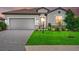 Charming single-Gathering home with a well-maintained lawn, stone accents, and a two-car garage at 15716 Barefoot Beach Dr, Bradenton, FL 34211